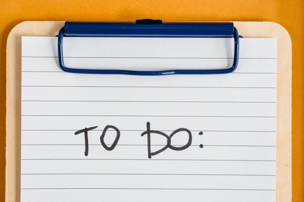 Clean and simple image of a to-do list on a clipboard with lined paper.